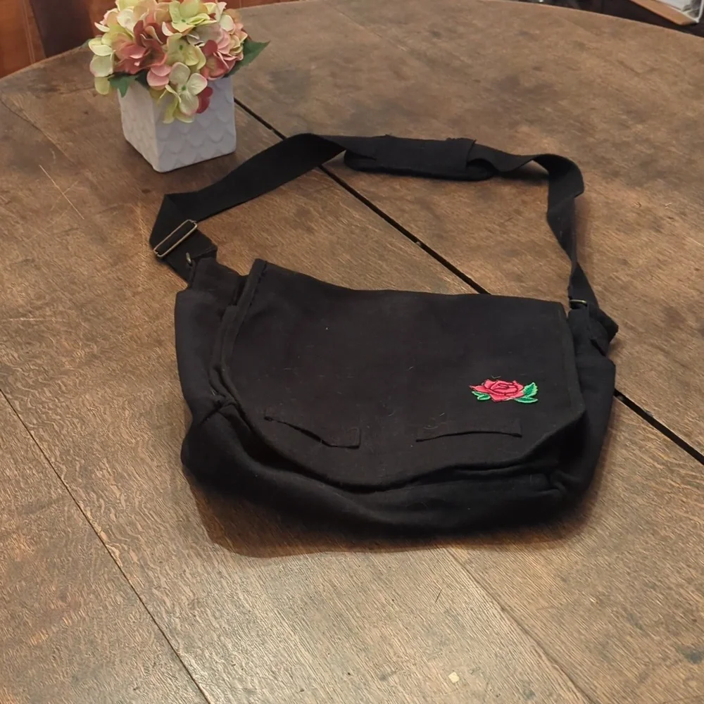 Black messenger bag with rose